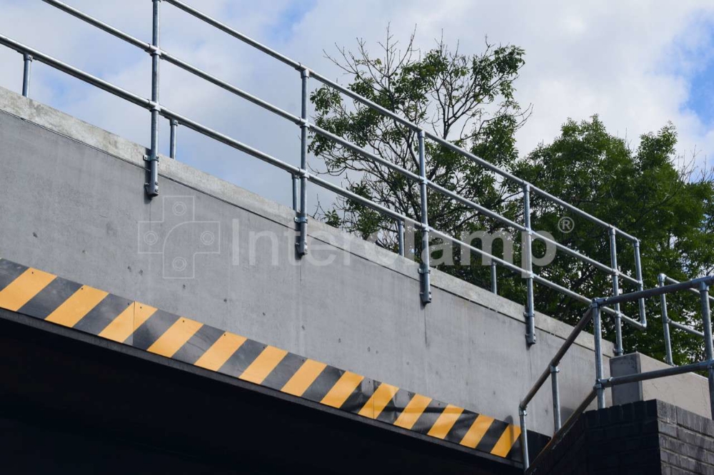 Interclamp key clamp fittings utilized in building a temporary guardrailing during a railway bridge replacement project, enhancing safety for the crew.